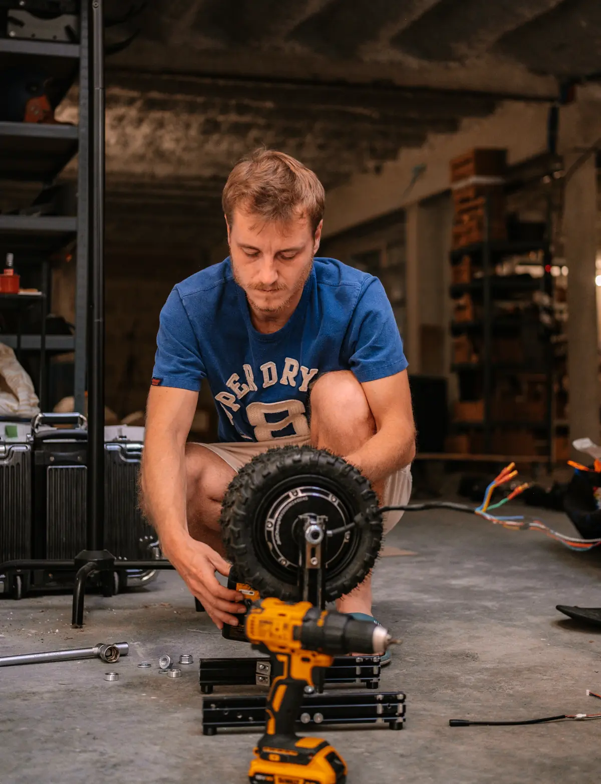 Édouard Aubert fitting a Stern' drive wheel with a power screwdriver in the workshop