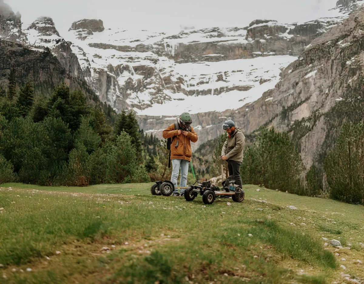 Riders and their Stern' boards in the mountains, at the foot of snow-capped peaks