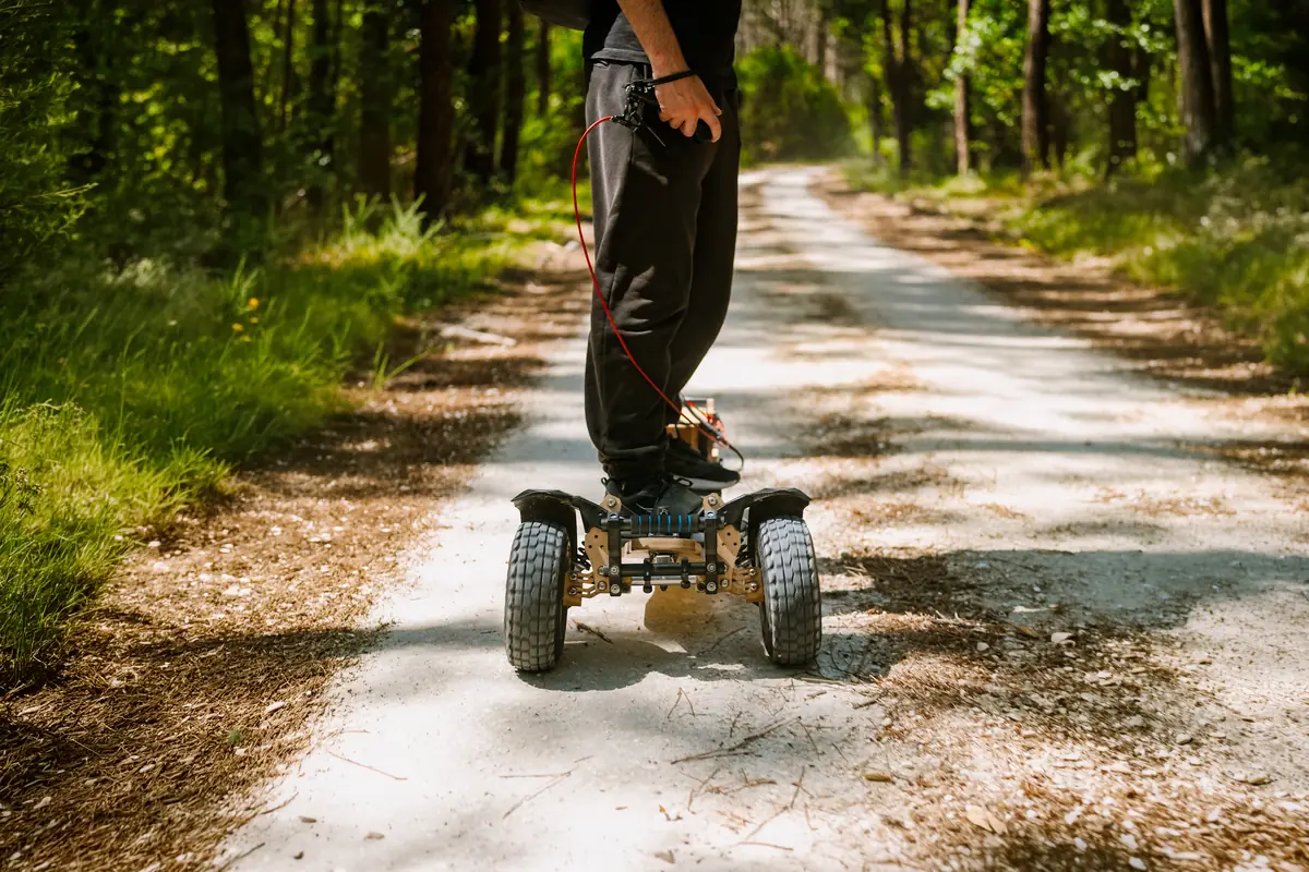 Close-up of the Stern' two all-terrain front wheels on a forest track