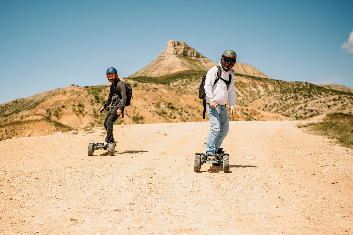 Two riders on a dirt track in the Bardenas desert