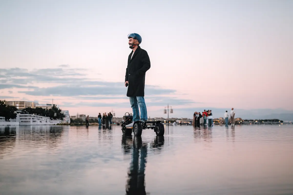 Rider standing on their Stern' on the Bordeaux water mirror at dusk