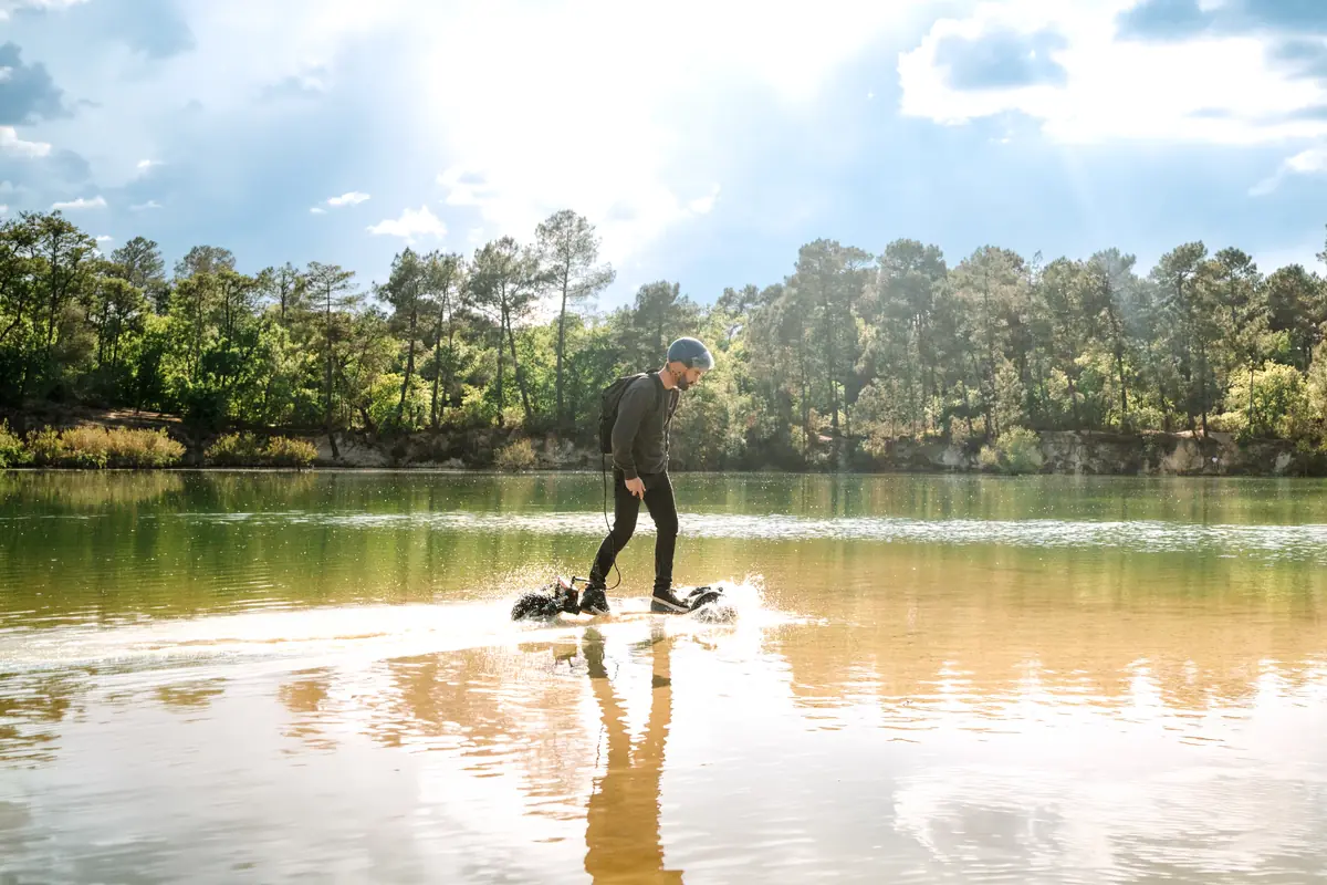 Rider on a Stern' crossing the shallow water of a pine-fringed lake, in the sunshine