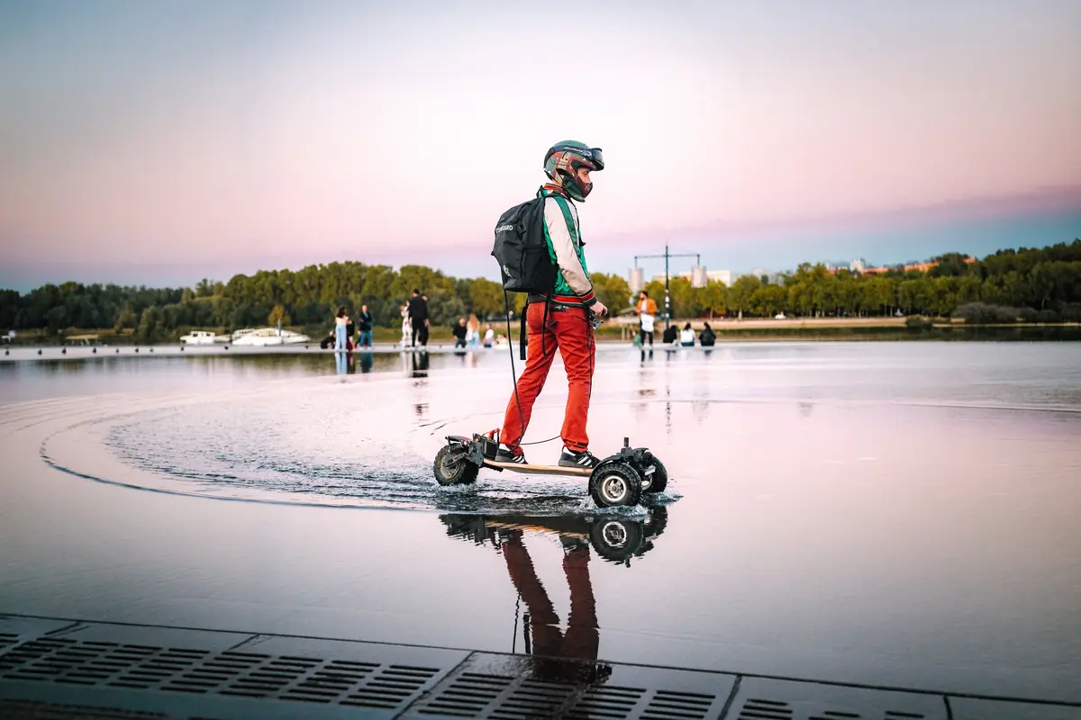 Rider in red trousers gliding across the Bordeaux water mirror