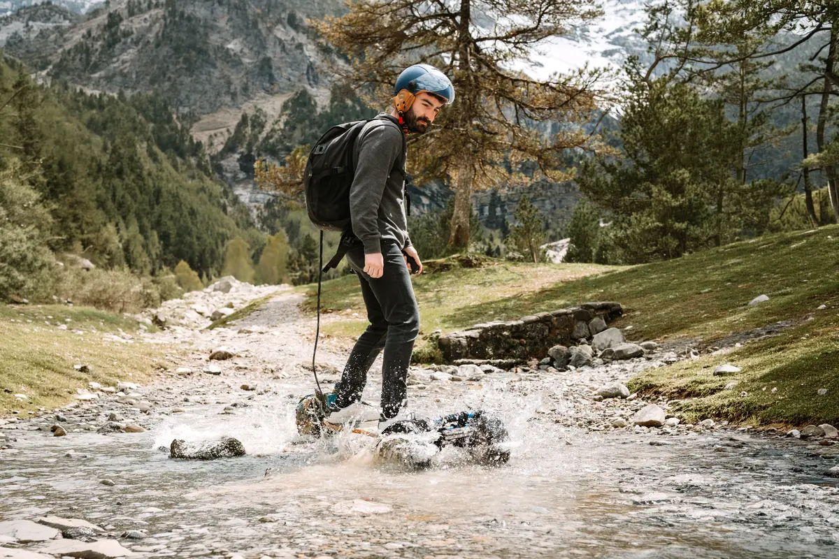 Rider crossing a mountain stream on their Stern', splashing