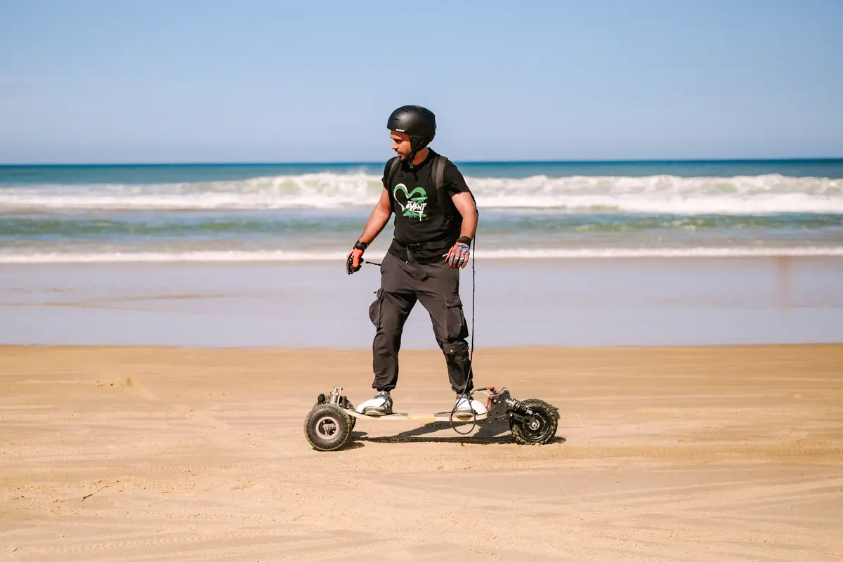 Helmeted rider on a Stern' on the hard sand at the water's edge