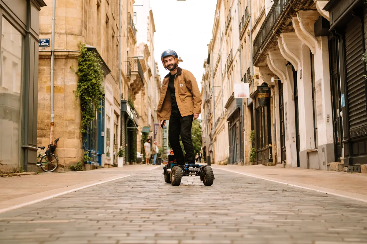 Smiling rider on their Stern' in a cobbled lane in the town centre